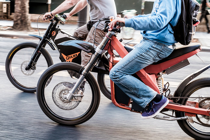 Two e-bike riders on the streets of Paris–Electric Night Ride on July 8, 2018. (Photo: Bob van Mol)