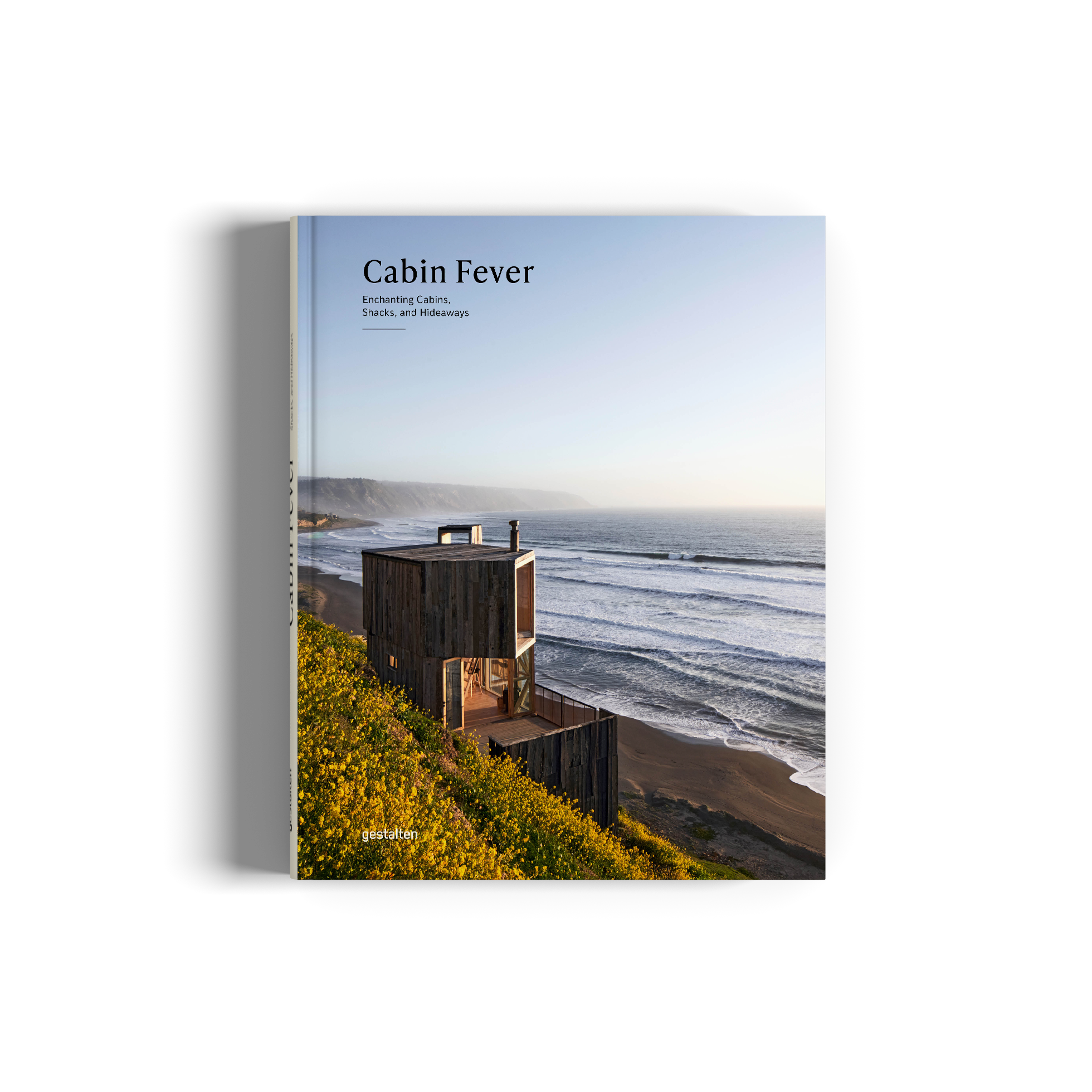 Cover of the book 'Cabin Fever' featuring a photograph of a cabin on a elevated site with ocean and hills in the background.