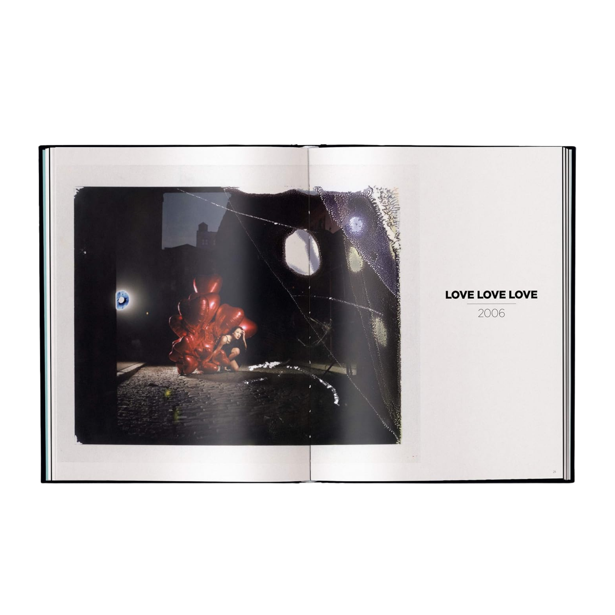 Open book showing a page with a black and white image and 'LOVE LOVE LOVE' text.