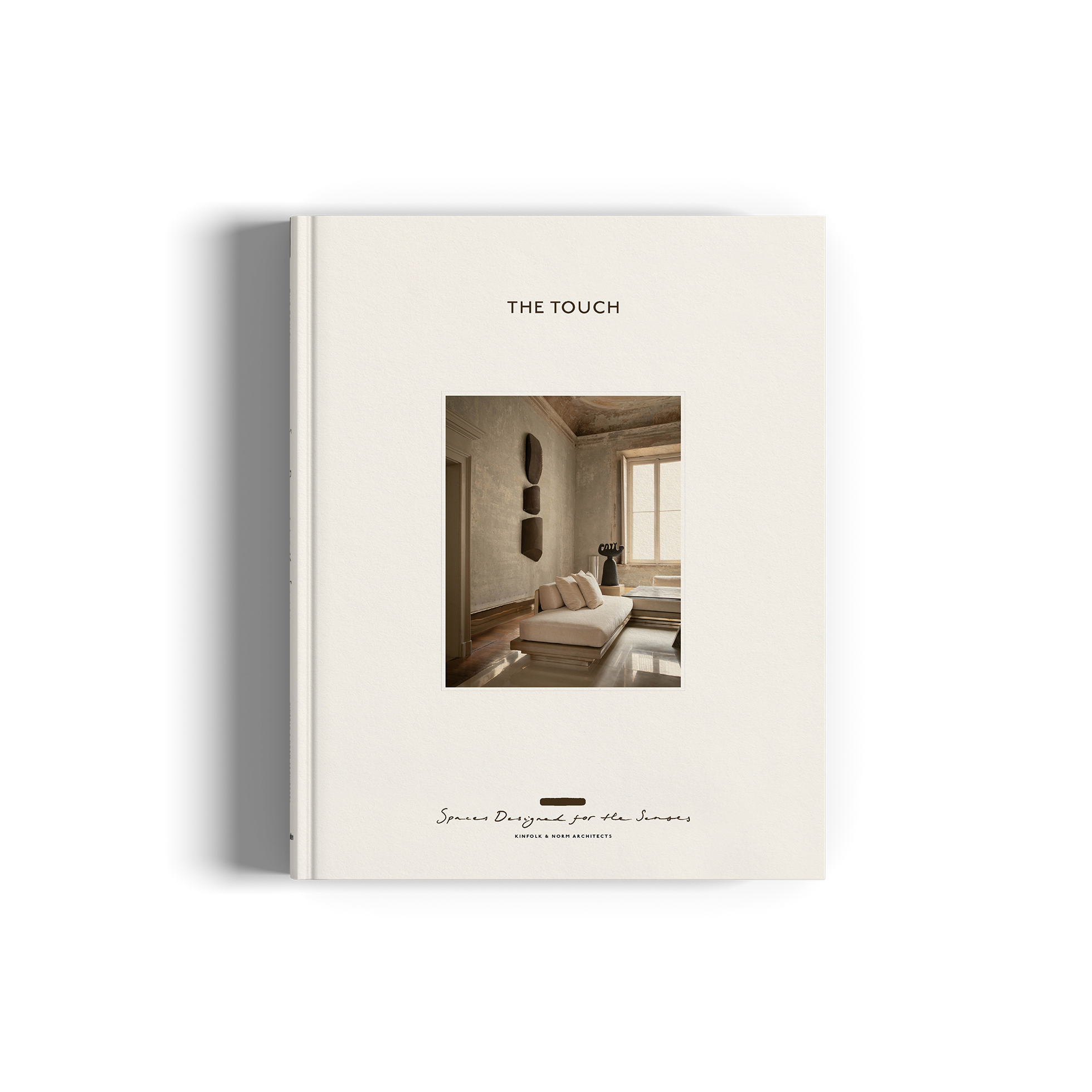 The image shows the cover of a book titled 'The Touch' with a white background. The cover features a minimalist design, depicting a serene indoor scene with a person seated in a chair, surrounded by simple, clean lines and a few decorative objects.