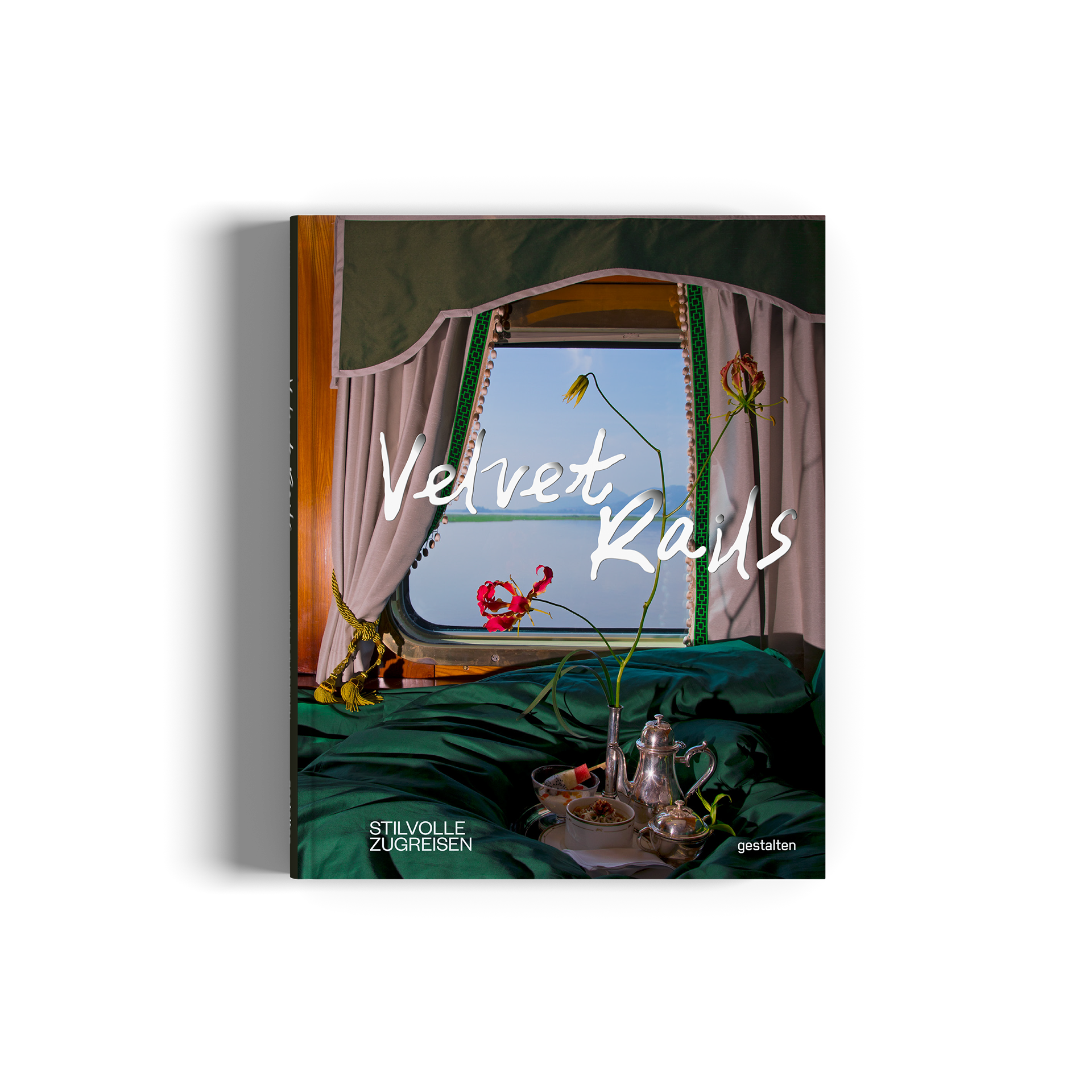 A hardcover book titled 'Velvet Rail' by gestalten, featuring a surreal still life illustration on the cover with green velvet, a window, and flowers.