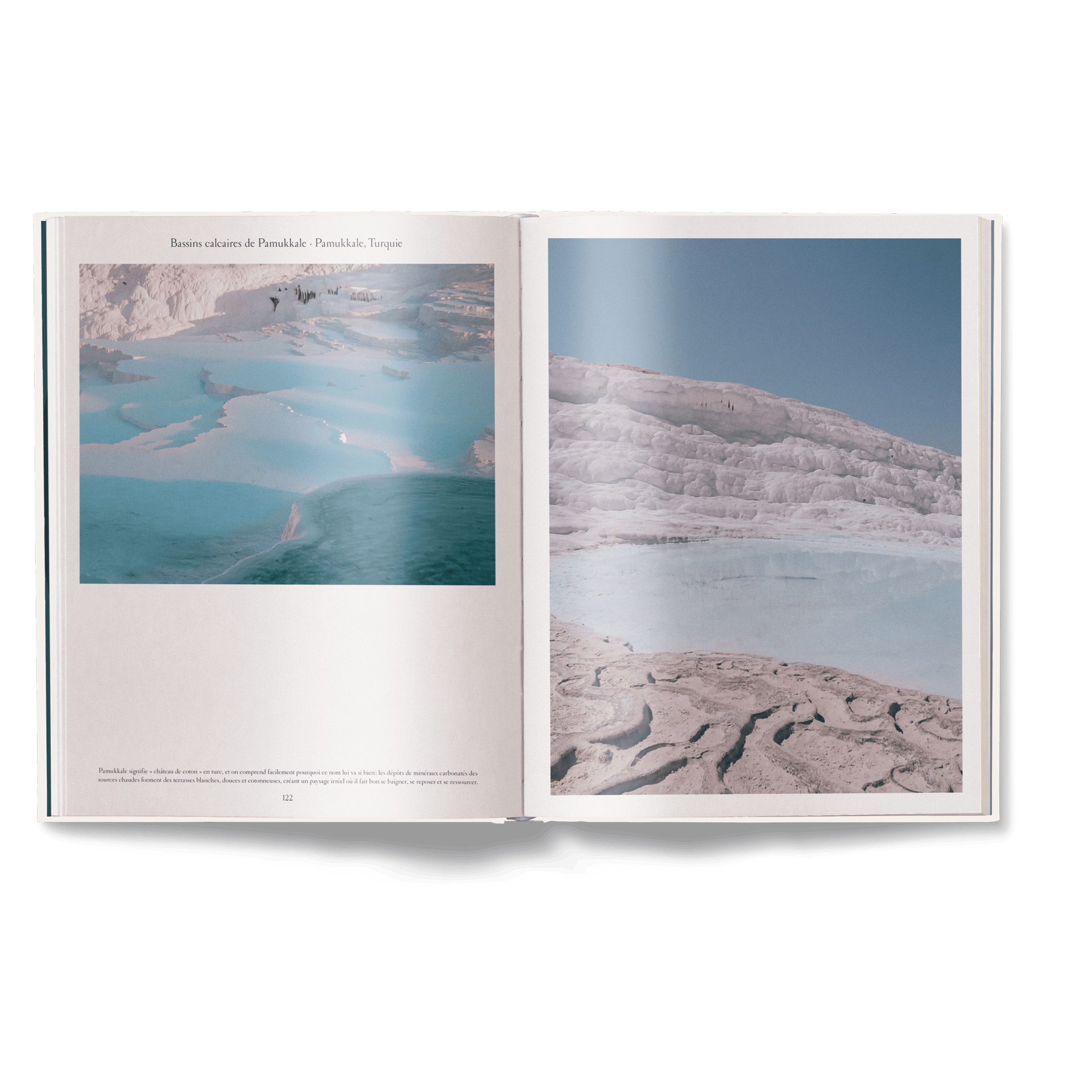 Open book showing a landscape with water and mountains on a white background