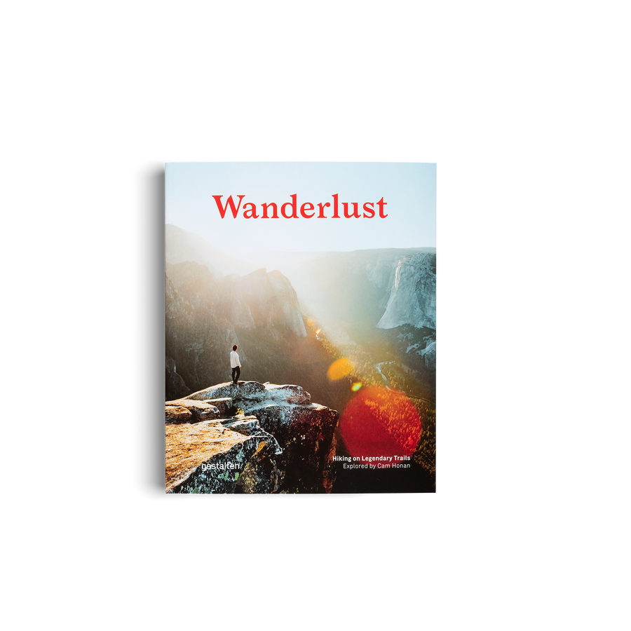 Book cover of 'Wanderlust' with a person standing on a cliff overlooking a valley.