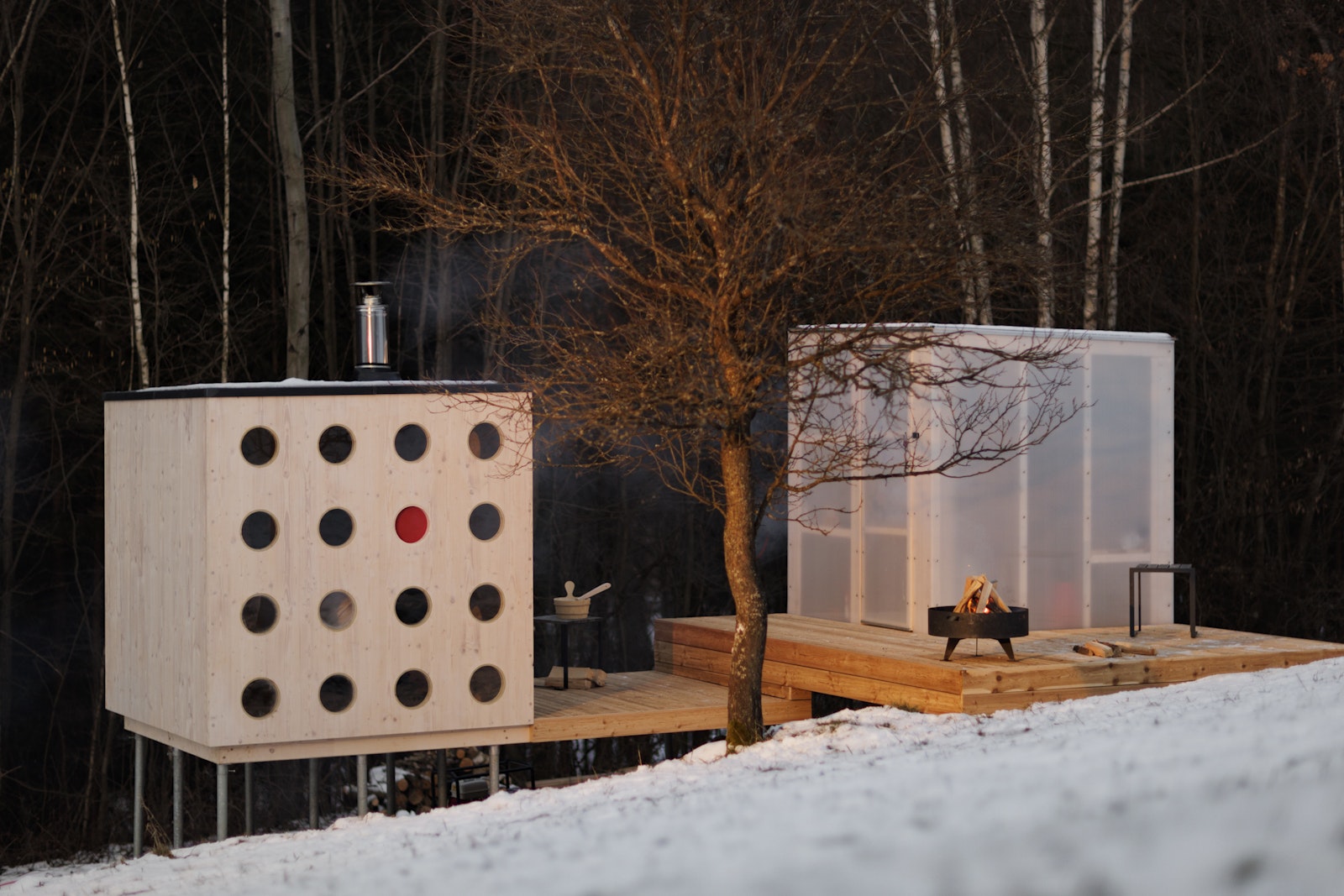 Modern outdoor cabin with geometric design in a snowy landscape