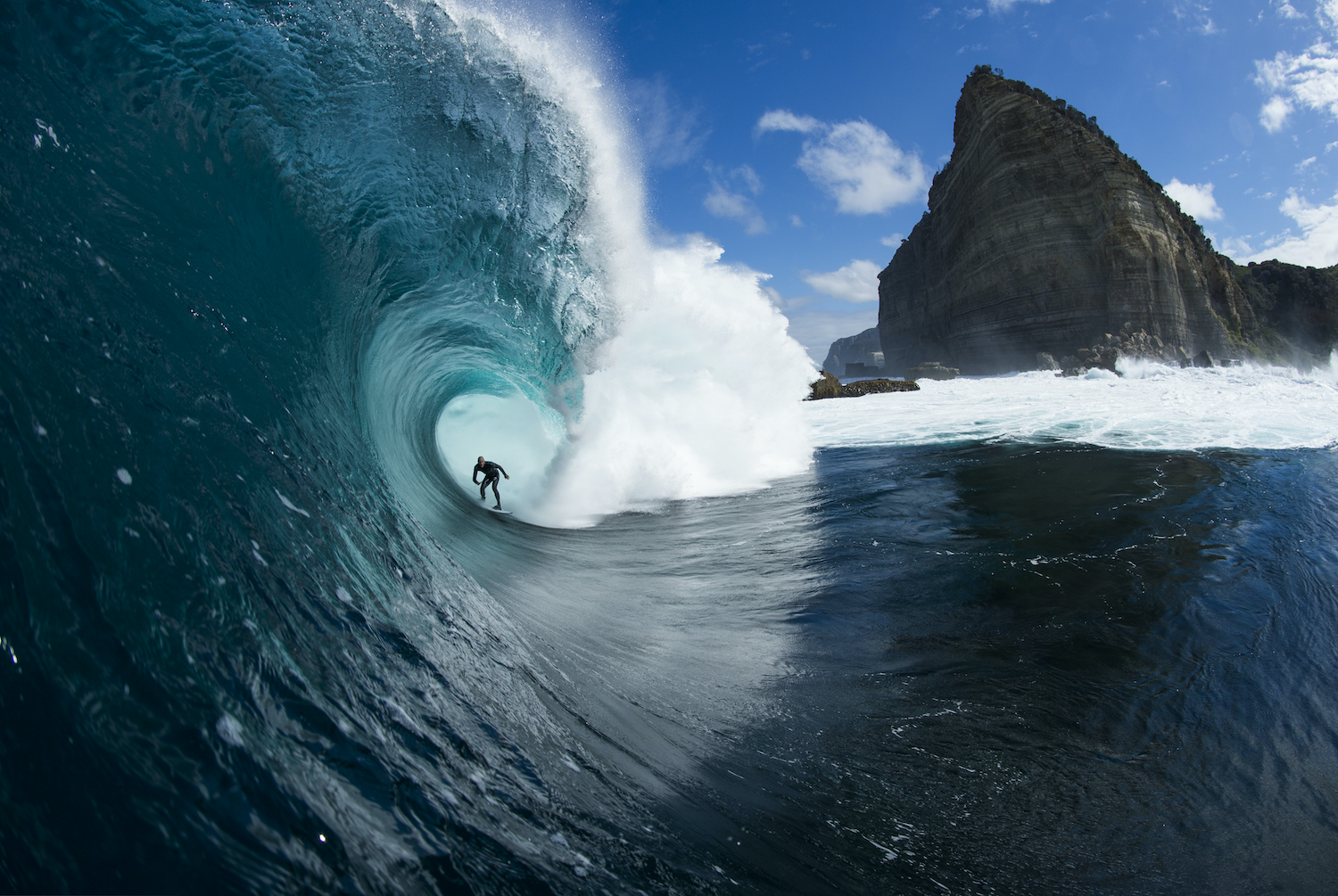 In the far southeast corner of the Tasman Peninsula, beneath a towering stern-shaped bluff, a series of boulder-strewn plateaus descend like a staircase into the seething ocean below. Shipstern Bluff in Australia, described as nature’s nastiest staircase is featured in The Surf Atlas by Luke Gartside.