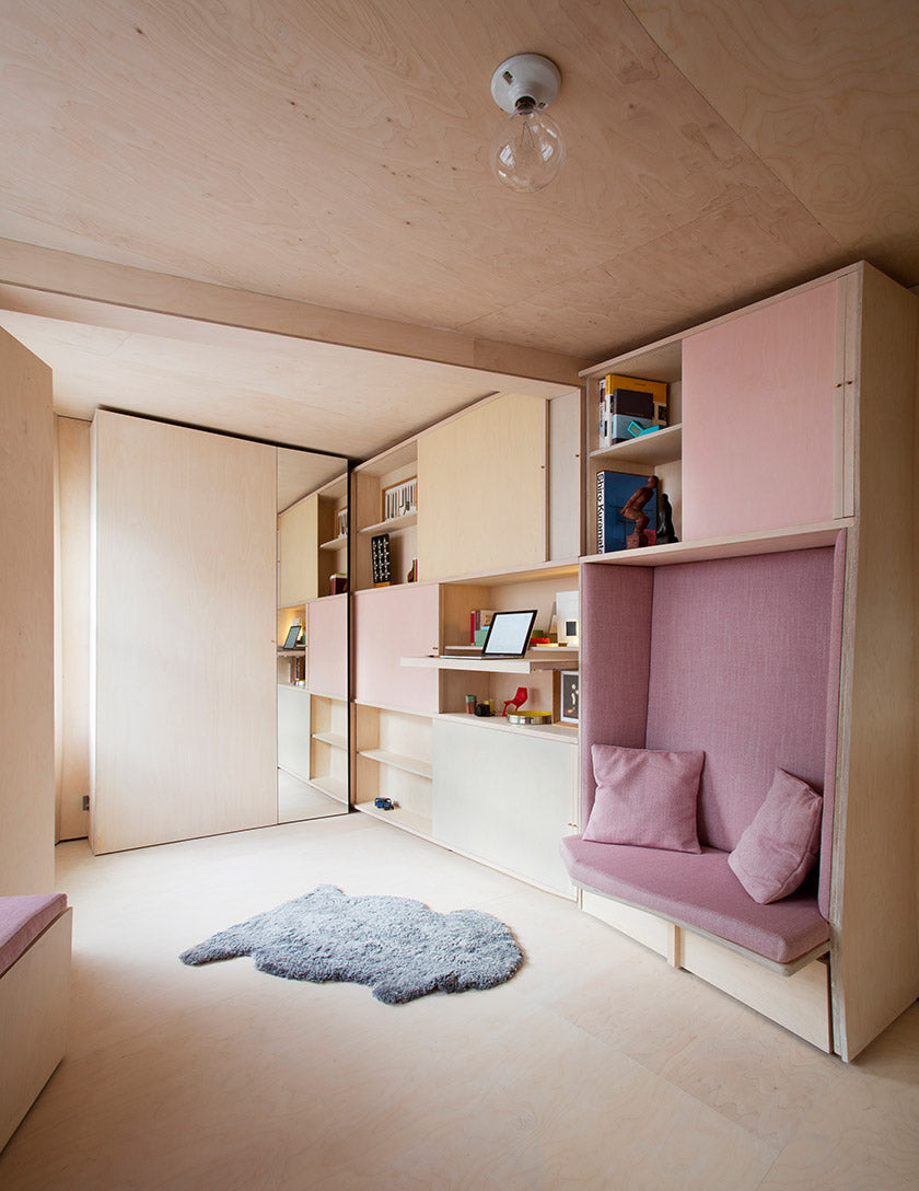 Sofa nook and double bed behind mirrored sliding door in a 13 square meter studio designed by Studiomama (Photo: Rei Moon)