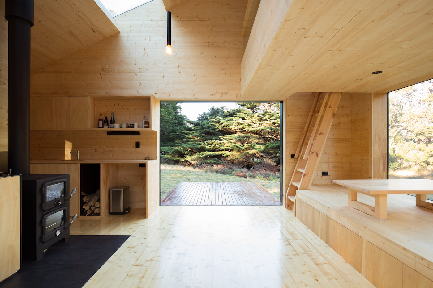 The living space in a cabin on Bruny Island (Tasmania, Australia). Floor, ceiling, and walls are panelled with timber. (Photo: Rob Maver)