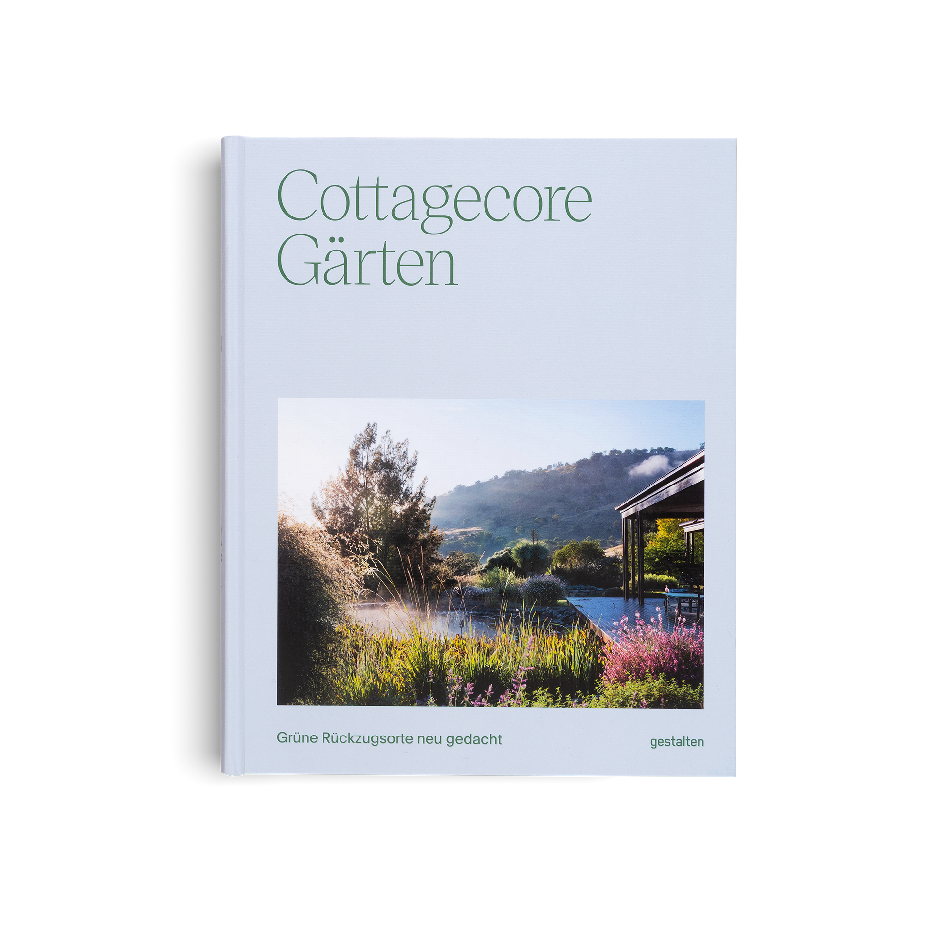 Book titled 'Cottagecore Gärten' with a scenic garden cover on a light blue background
