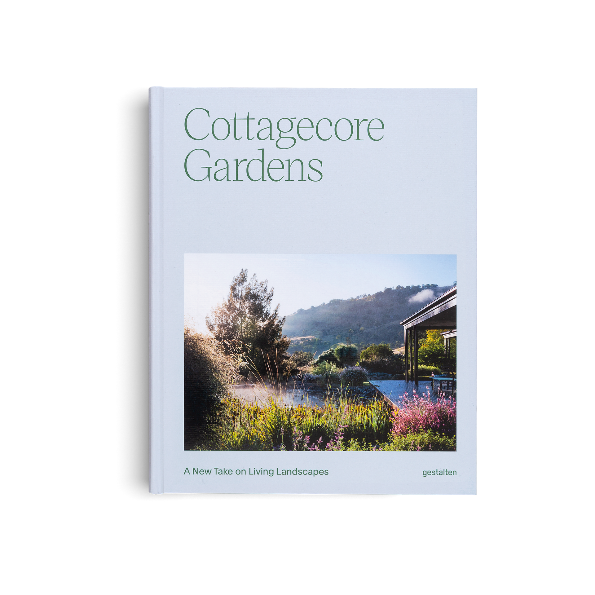 Book titled 'Cottagecore Gardens' with a scenic garden cover on a light blue background