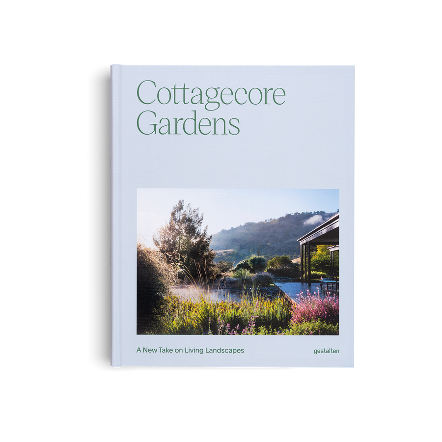 Book titled 'Cottagecore Gardens' with a scenic garden cover on a light blue background