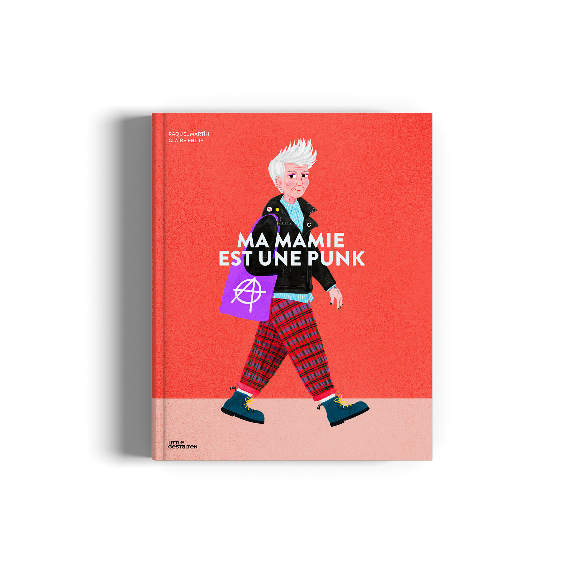 A hardcover book titled 'MA MAMIE EST UNE PUNK'  featuring a vibrant red cover with an illustration of a punk woman walking and a light pink band cover.