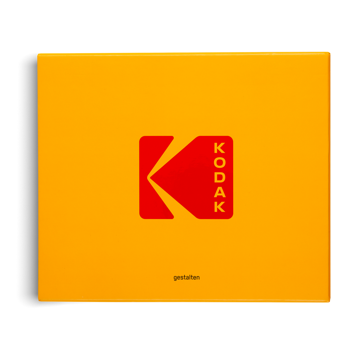 A square yellow-orange product box featuring the red Kodak logo and the word 'KADOK' in the center, with a small 'gestalten' mark near the bottom, shown on a white background.