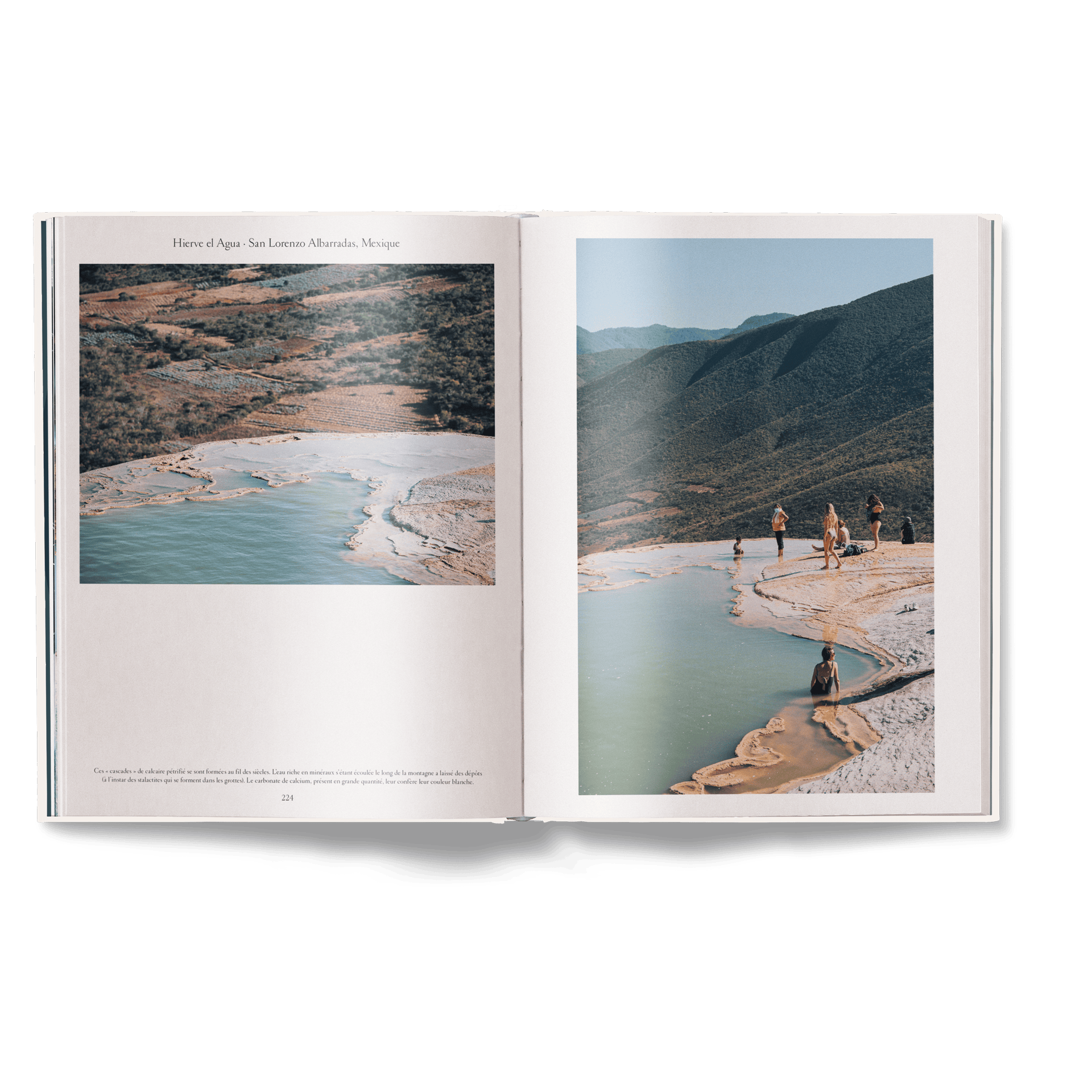 Open book showing a scenic landscape with a lake and mountains.