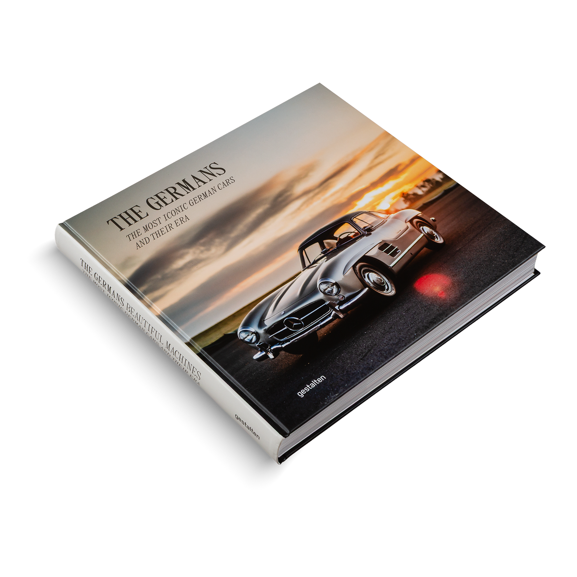 Book titled 'The Germans' with a vintage car on the cover against a sunset background