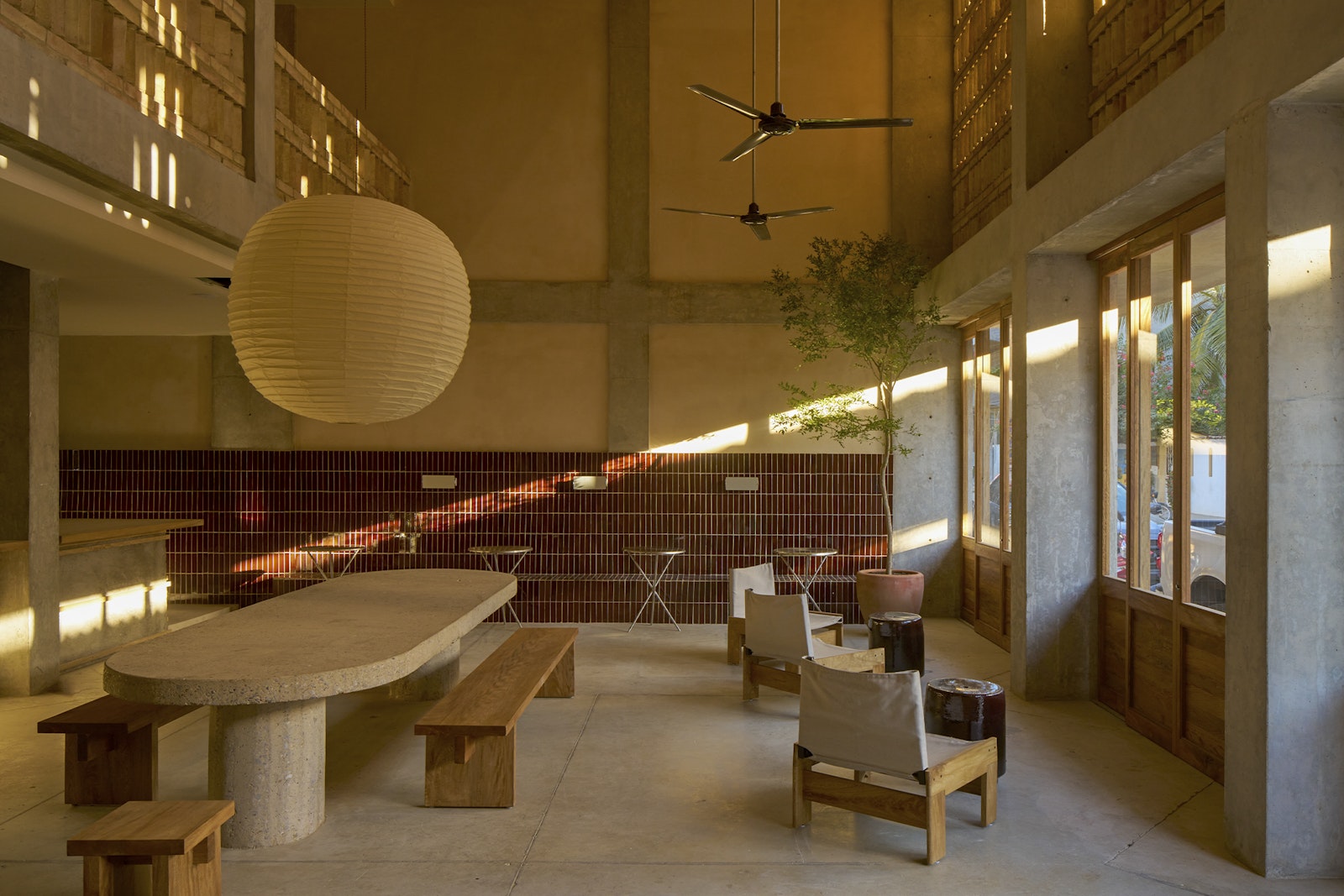 Modern interior with a large round table and chairs in a well-lit room.