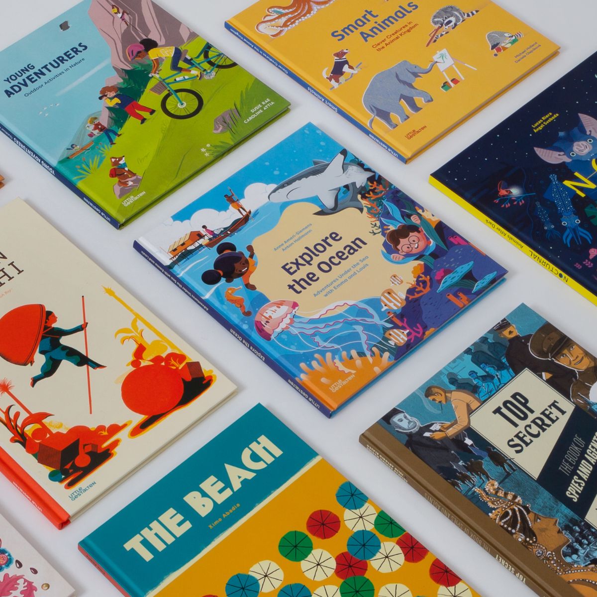 Collection of children's books with colorful covers on a white surface