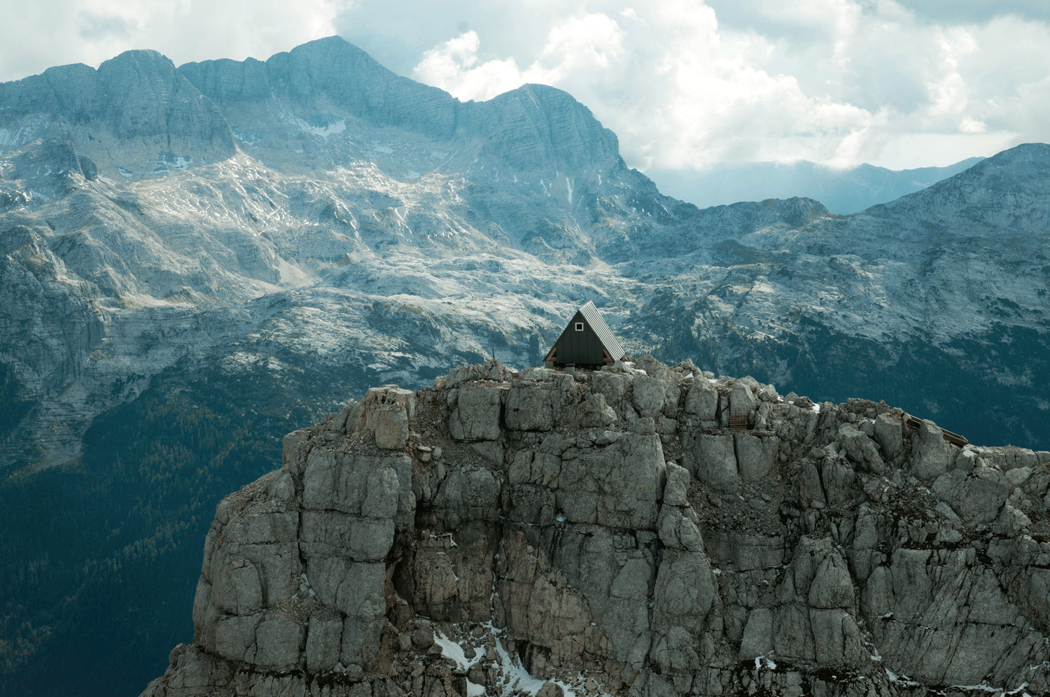 A cabin on a mountain peak