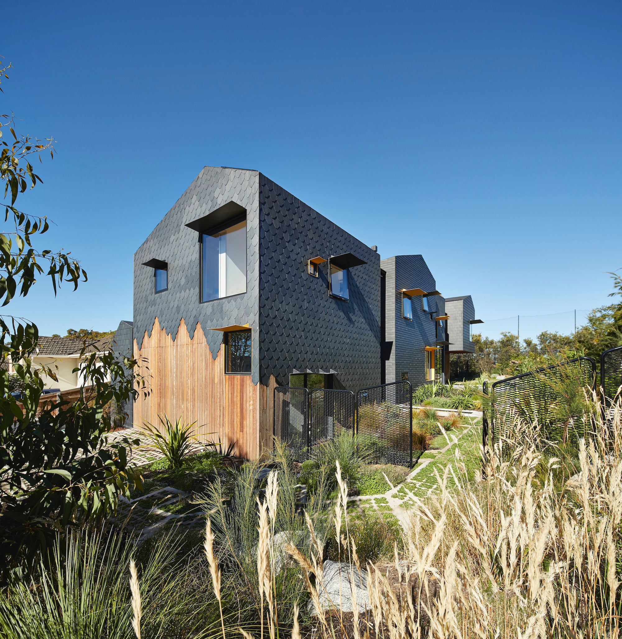 Charles House, with its contrasting shapes, angles, textures, and materials, is a distinct piece of residential architecture. The multigenerational home was designed for longevity for a family of five, plus grandparents, that they could live in for at least 25 years.
