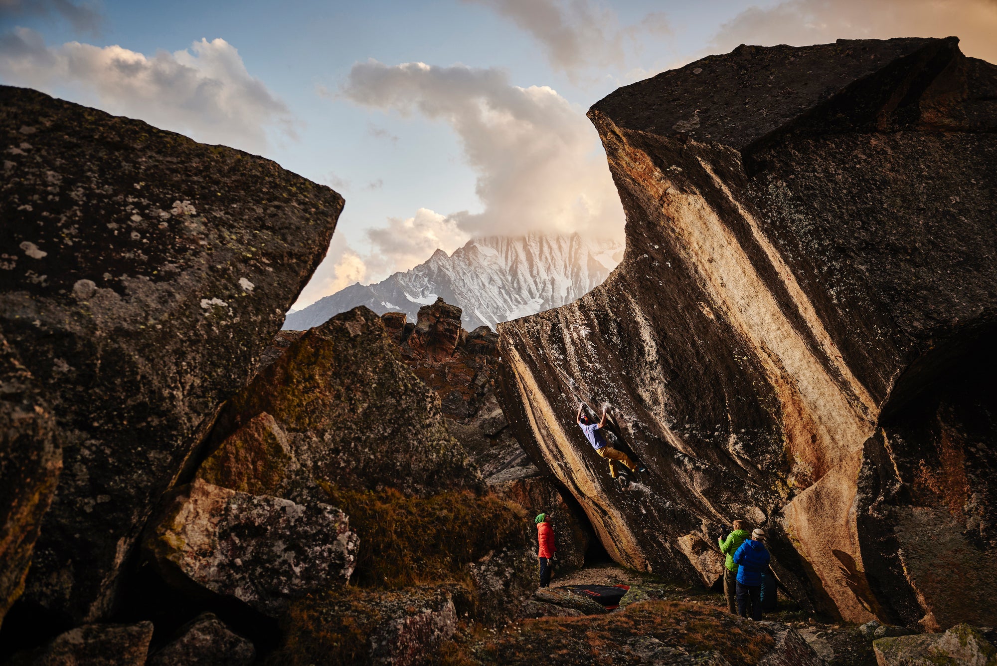 Boulderers on a rock. Bouldering and the sense of community in the climbing culture.