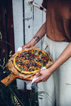 This recipe of vegan and gluten-free pizza with sweet-potato dough is featured in A Year with Our Food Stories by Nora Eisermann and Laura Muthesius.