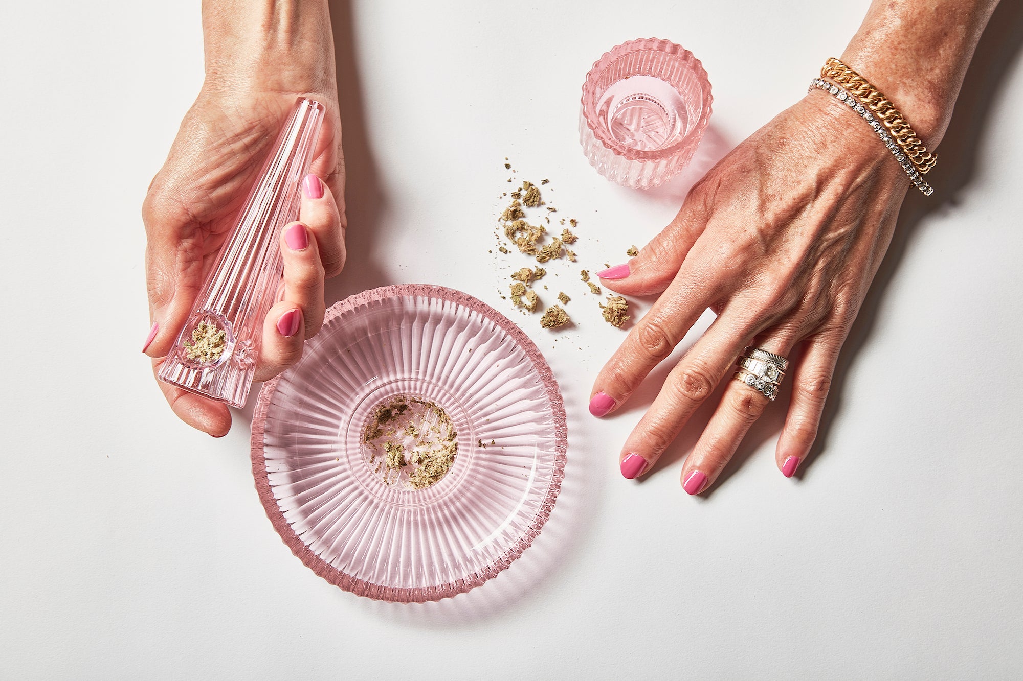 Fashioned from rose-pink ridged glass, this elegant three-piece set of marijuana accessories features an ashtray, grinder, and pipe in High on Design